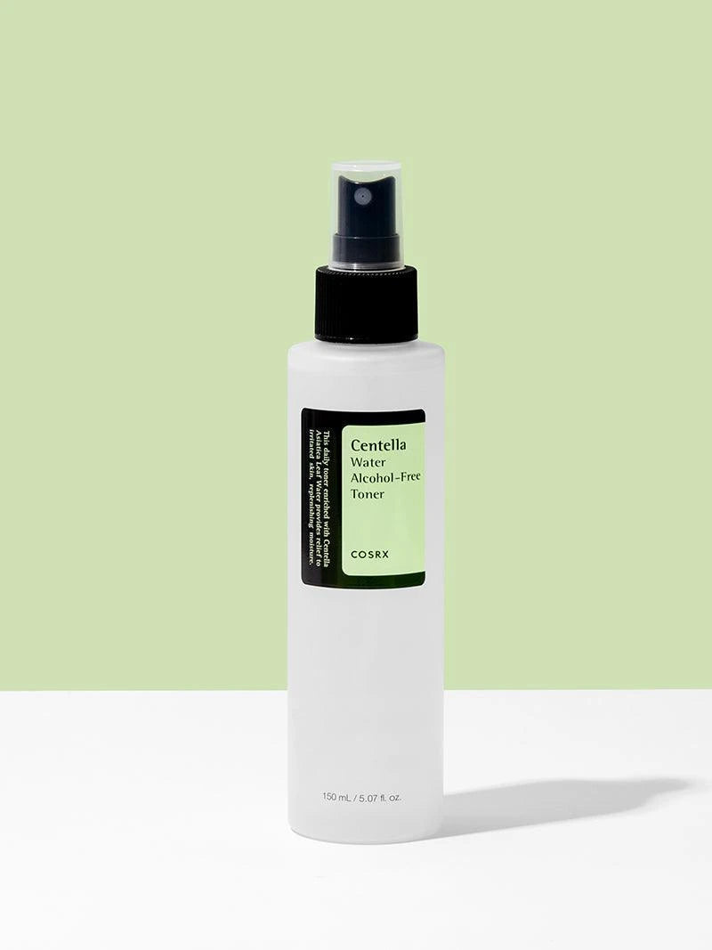 White bottle with black spray nozzle on a light green background