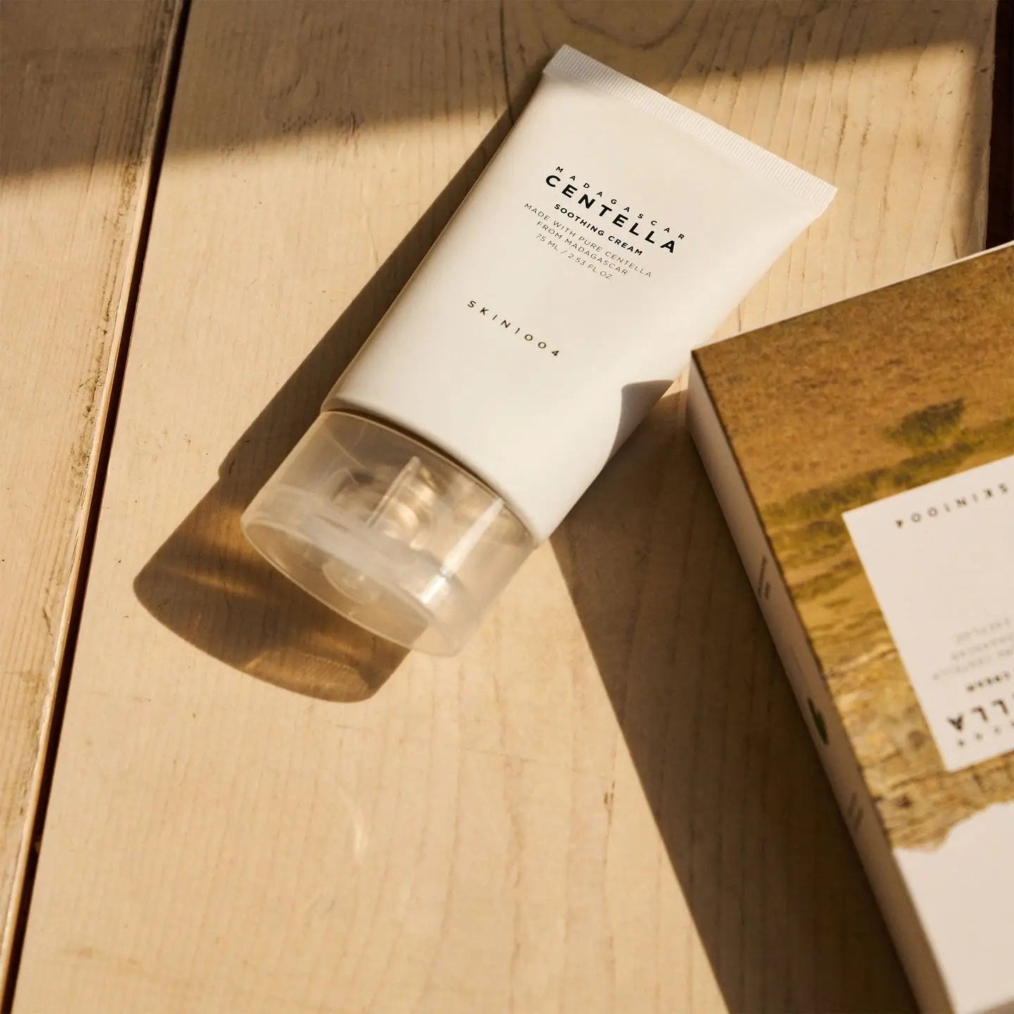 Skincare product with Centella Asiatica on a wooden surface
