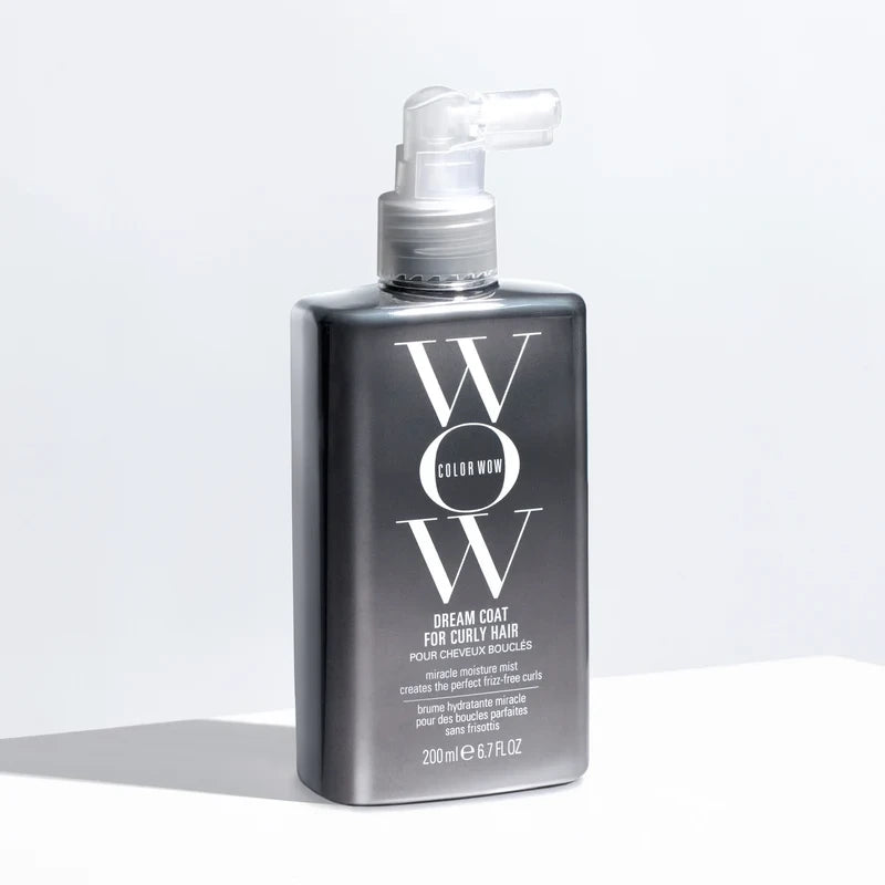 A 200ml bottle of Color Wow Dream Coat for Daily Hair, featuring a matte black rectangular design with a clear pump dispenser, set against a clean white background with a soft shadow.
