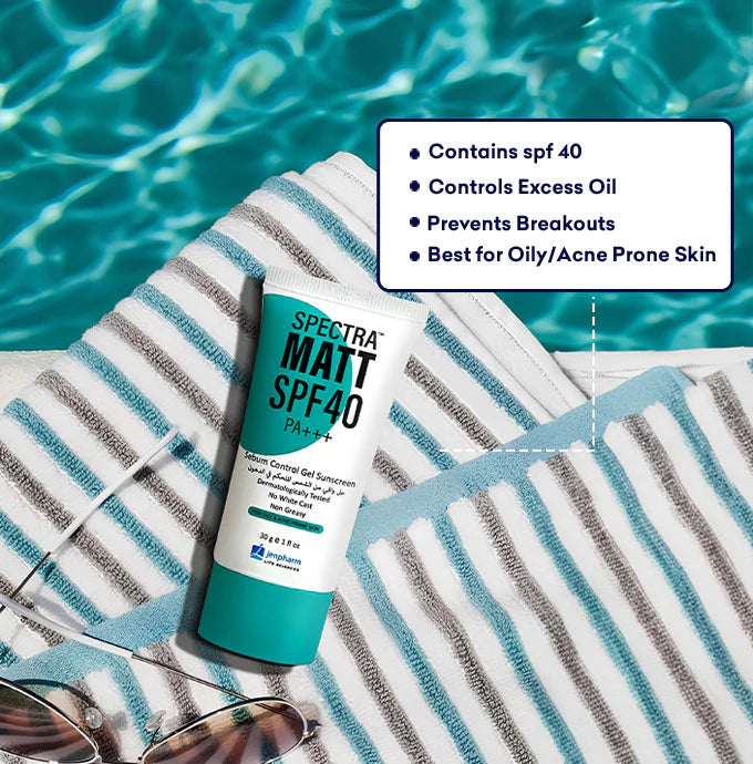 Spectra Matt SPF40 sunscreen tube on a striped towel with pool background