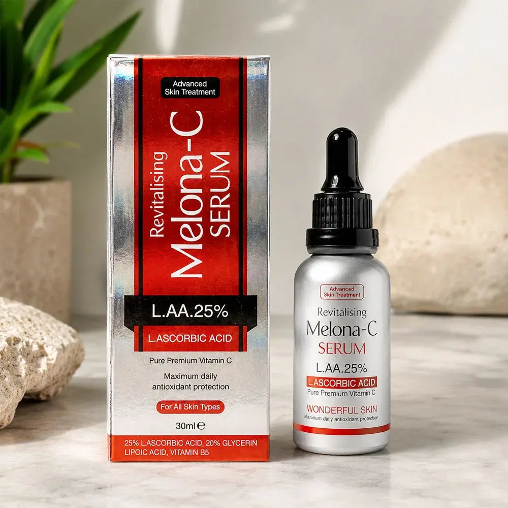 A skincare product set featuring a box and bottle of Revitalising Melona-C Serum with L.AA, 25% Ascorbic Acid, styled on a marble surface with decorative stones and a plant in the background.
