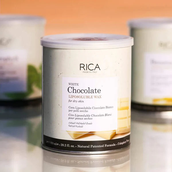 RICA White Chocolate liposoluble wax canister on a reflective surface with an orange background