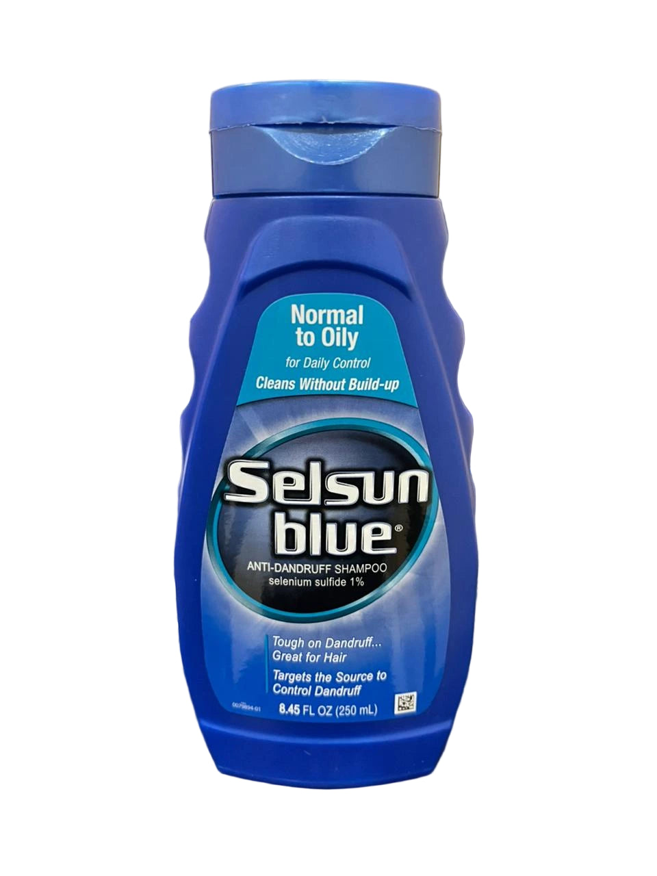 Selsun Blue shampoo bottle on a desk 